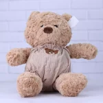 عروسک پولیشی خرس قهوه‌ ای با لباس مخملی کرم